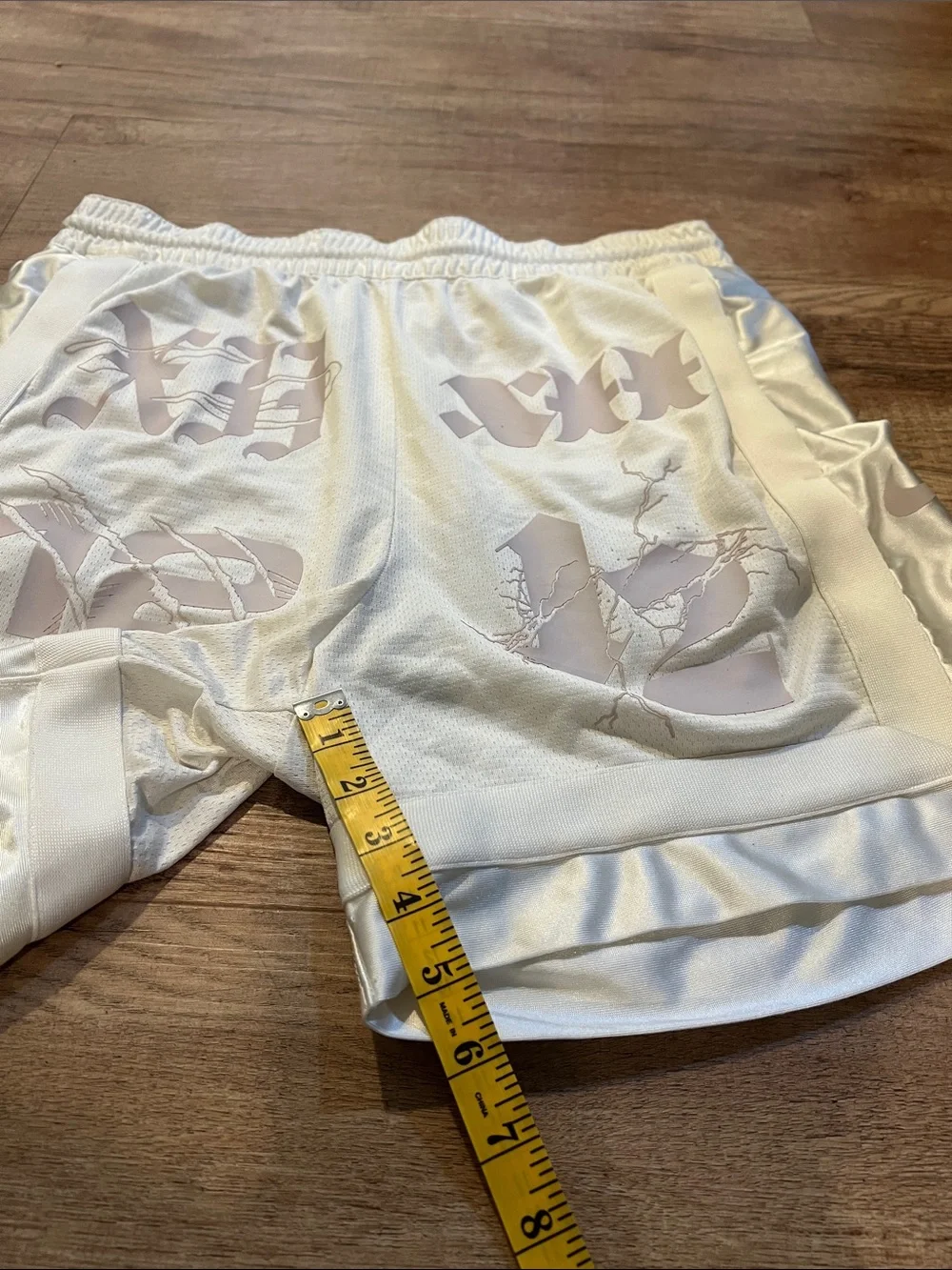 Nike Men’s White Athletic Shorts with Pale Pink Graphic